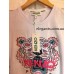 Женская футболка KENZO белого цвета купить, на сайте супермаркета - интернет магазин одежды и нижнего белья «Элегант» Сумы (Украина) - каталог женской одежды коллекции моды (смотреть онлайн бесплатно видео и фото девушки топ модели)